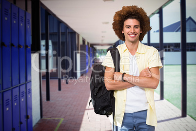 Composite image of young man with arms crossed in office corridor