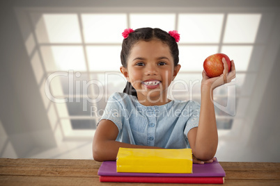 Composite image of smiling girl holding apple