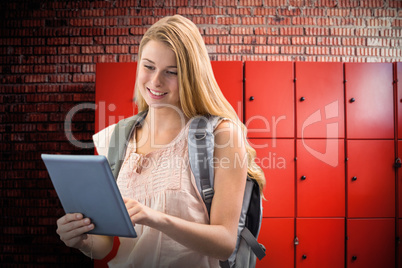 Composite image of happy student using tablet