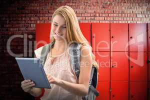 Composite image of happy student using tablet