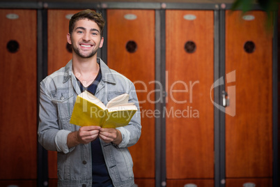 Composite image of student smiling at camera in library