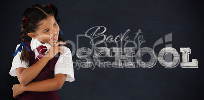 Composite image of thoughtful schoolgirl over white background