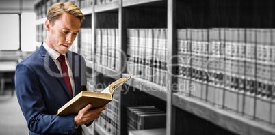 Lawyer reading in library at university
