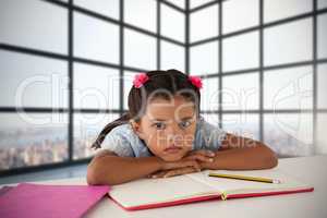 Composite image of girl leaning on open book at desk
