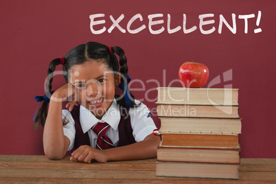 Composite image of schoolgirl leaning by books and apple on desk