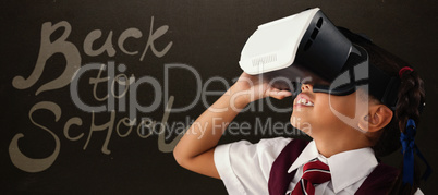 Composite image of close-up of schoolgirl using virtual reality headset