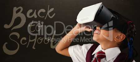 Composite image of close-up of schoolgirl using virtual reality headset