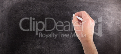 Composite image of hand writing with chalk