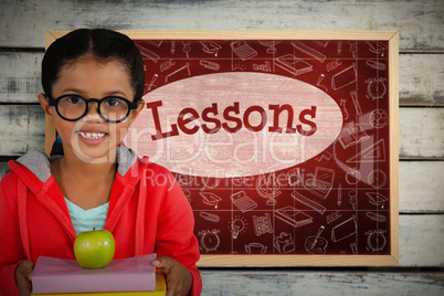 Composite image of happy girl holding books and apple