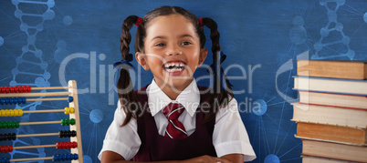 Composite image of cheerful schoolgirl with stack of books