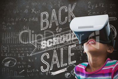 Composite image of close up of girl using virtual reality simulator