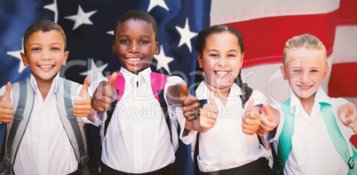 Composite image of portrait of students showing thumbs up sign