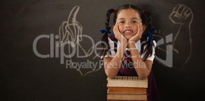 Composite image of schoolgirl leaning on stack of books