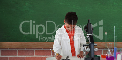 Composite image of schoolboy writing on note pad