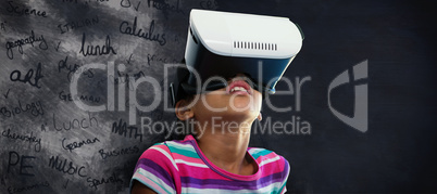 Composite image of close up of girl using virtual reality simulator