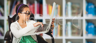 Composite image of young girl typing on laptop while sitting