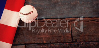 Baseball ball and American flag on table