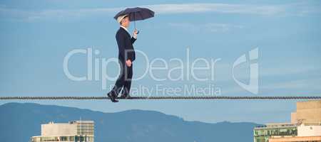 Composite image of businessman with umbrella walking on white background