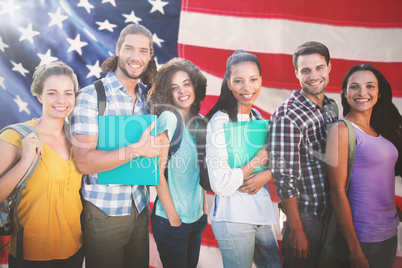 Composite image of smiling group of students standing in a row