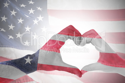 Composite image of couple making heart shape with hands