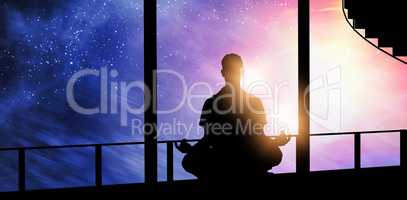 Composite image of silhouette man doing meditation
