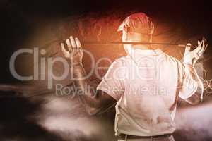 Composite image of rear view of golf player holding a golf club