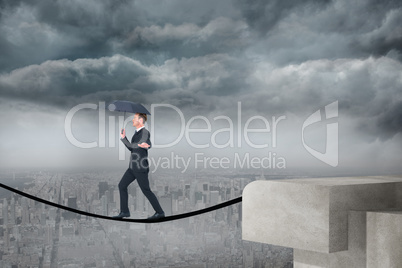 Composite image of concentrated businessman with umbrella walking