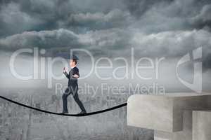 Composite image of concentrated businessman with umbrella walking