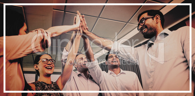 Business colleagues giving high five during meeting in office