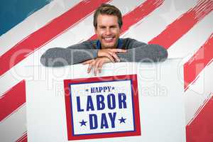 Composite image of smiling man on table against white background