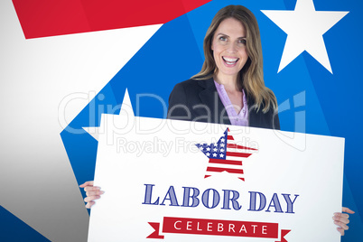 Composite image of beautiful businesswoman holding blank billboard over white background