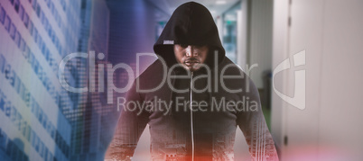 Composite image of male robber in black hoodie standing