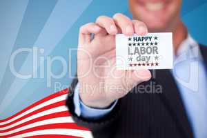 Composite image of businessman holding blank card against white background