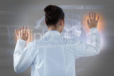Composite image of female doctor using digital screen against white background