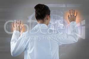 Composite image of female doctor using digital screen against white background