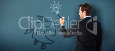 Composite image of businessman standing back to camera writing with marker