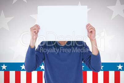 Composite image of man holding blank sign in front of face