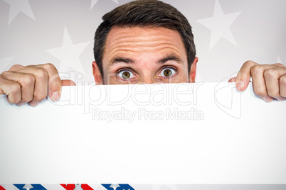 Composite image of man holding blank sheet