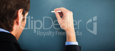 Composite image of businessman writing with a white chalk