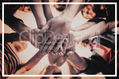 Creative business team stacking hands together
