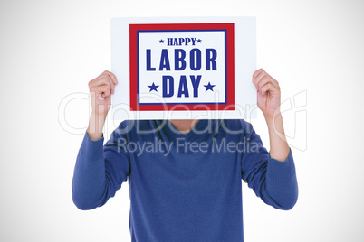 Composite image of man holding blank sign in front of face