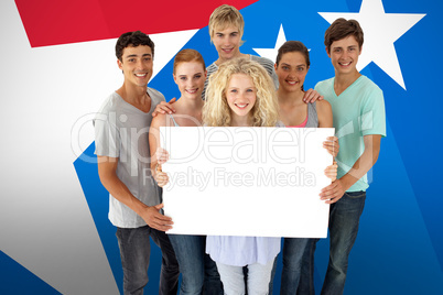 Composite image of group of teenagers holding a blank card