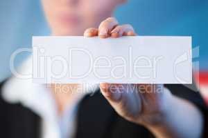 Composite image of close up of businesswoman holding blank card