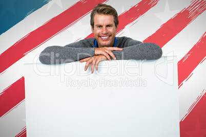 Composite image of smiling man on table against white background