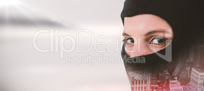 Composite image of portrait of female hacker wearing balaclava