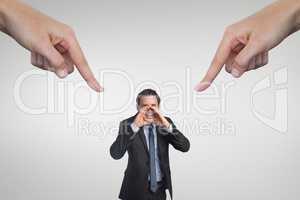 Hands pointing at business man against white background