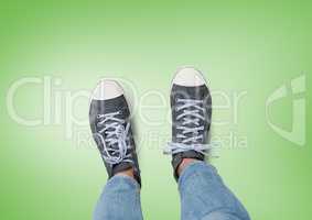 grey shoes on feet with green background