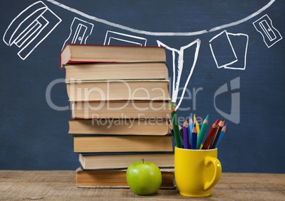 Books on the table against blue blackboard with graphics