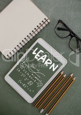 Tablet on a school table with school icons on screen