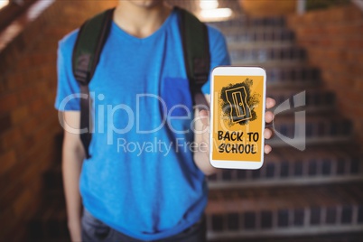 Boy holding a phone with back to school text on screen
